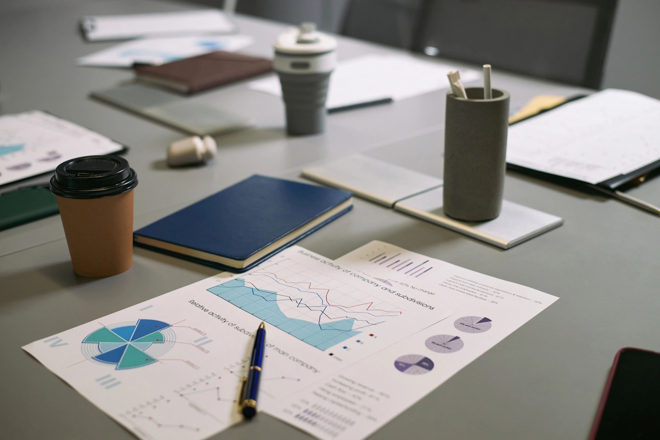 Editorial desk with charts and documents representing disciplined analytical forecasting