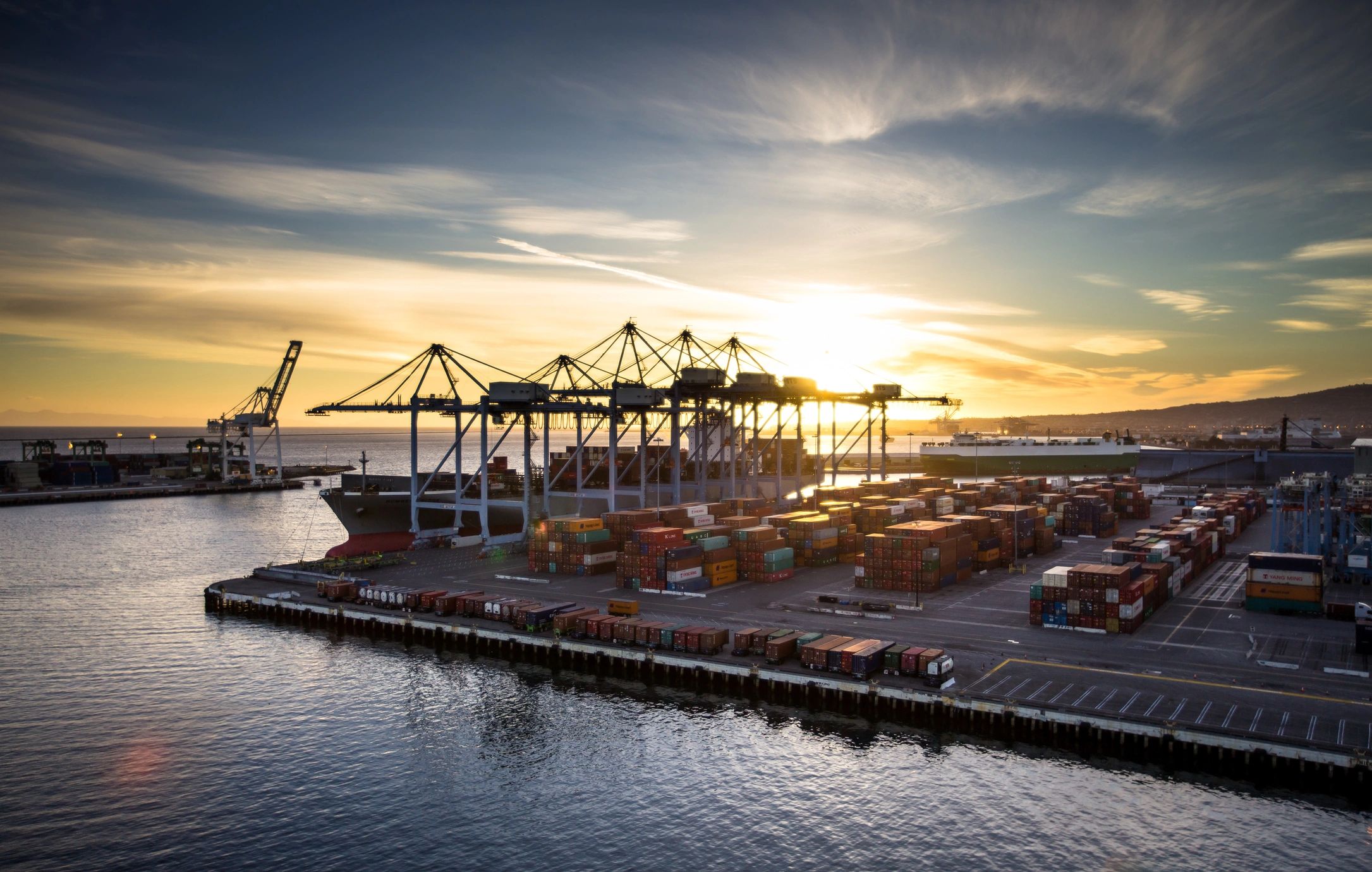 Shipping container yard at sunset in a major port